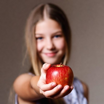 Girl holding red apple