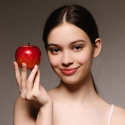 Girl holding red apple