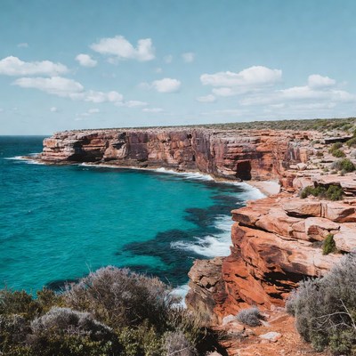 Red Cliffs Over Turquoise Ocean Bay