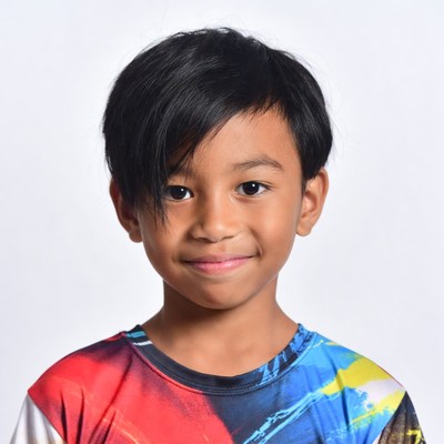 Asian boy smiling in colorful shirt
