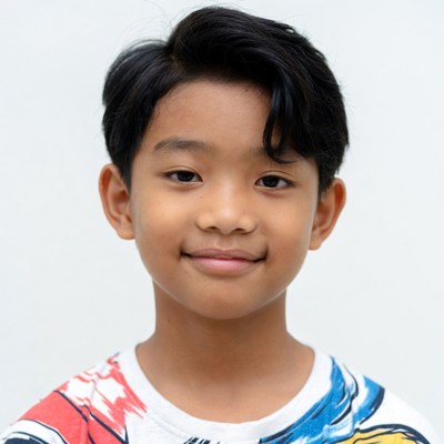 Asian boy smiling in colorful shirt