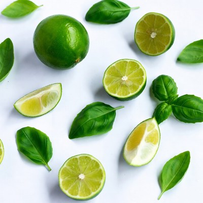 Fresh limes and basil leaves