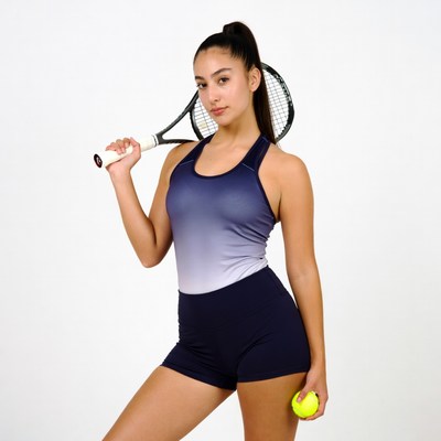 Young woman holding tennis racket and ball