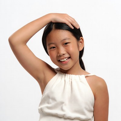 Asian girl smiling hand on head