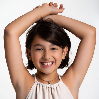 Smiling girl raising arms overhead