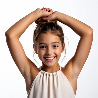 Girl smiling with arms raised in bun
