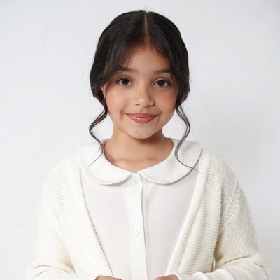 Young Asian girl smiling in white outfit