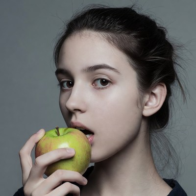 Girl biting green apple