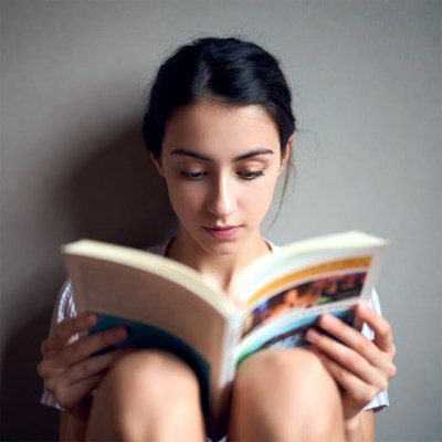 Young woman reading book