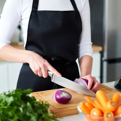 Woman chopping vegetables in kitchen