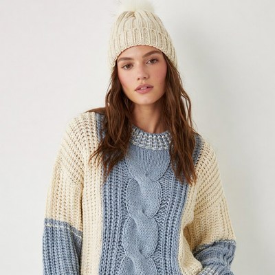 Woman in white blue knit beanie sweater