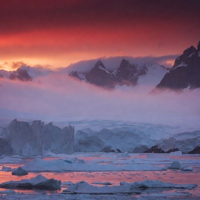 Red Sunset Over Icy Mountains and Glaciers