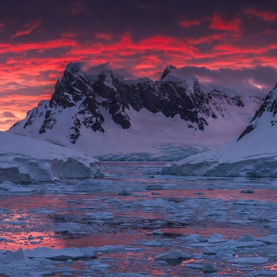Red Sunset Over Antarctic Iceberg Mountains