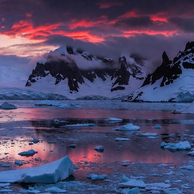 Antarctic Mountains at Sunset with Icebergs