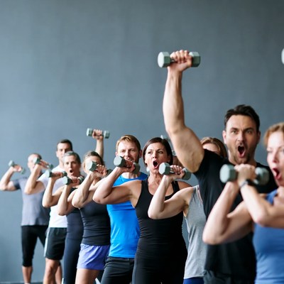 Group fitness class lifting dumbbells