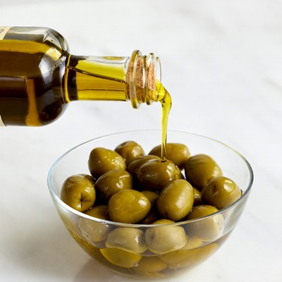 Olive Oil Pouring on Olives