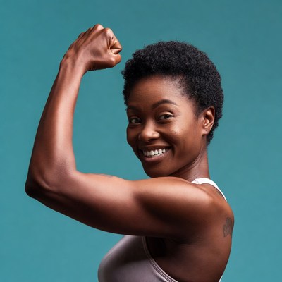 African-American woman flexing bicep