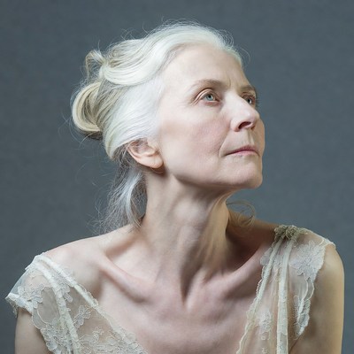 Elderly woman with white hair looking up