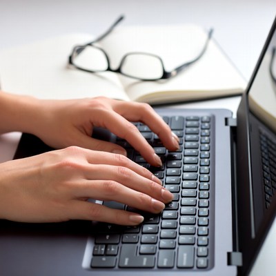 Woman typing on laptop