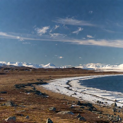 Snowy Mountains and Frozen Lake Shoreline