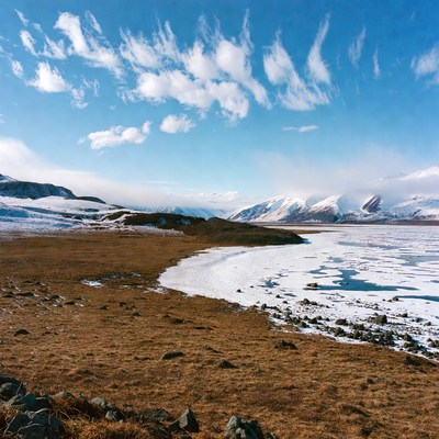 Frozen Lake with Snowy Mountains