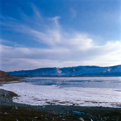 Frozen Lake with Snowy Mountains