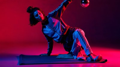 Asian woman balancing yoga ball