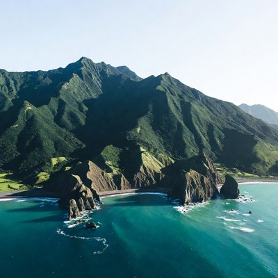 Lush Green Mountains and Turquoise Bay