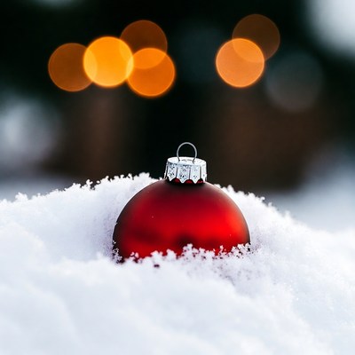 Red Christmas ornament in snow