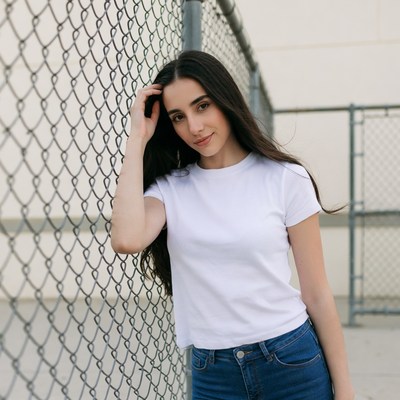 Woman leaning on chain link fence