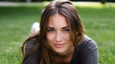 Beautiful woman lying on grass