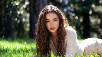 Beautiful woman lying in grass forest