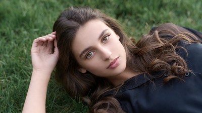 Beautiful woman lying on grass