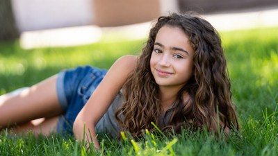 Girl lying on grass smiling
