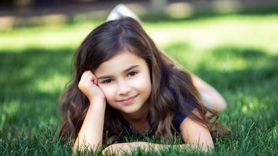 Young girl lying on grass