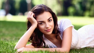 Beautiful woman lying on grass