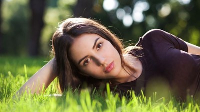 Beautiful woman lying on grass