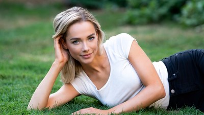 Blonde woman lying on grass