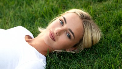 Blonde woman lying on grass