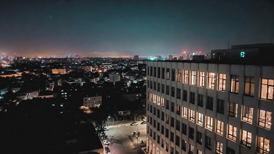 Night cityscape with lit high-rise building