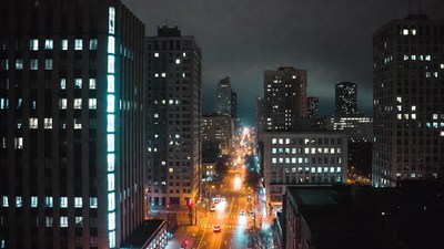 Night city street with skyscrapers