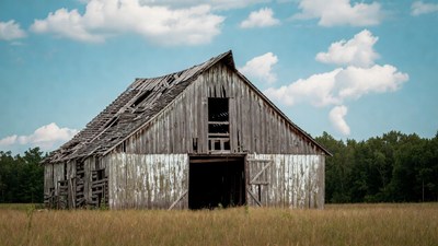 Old abandoned barn in field