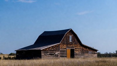 Old wooden barn in field