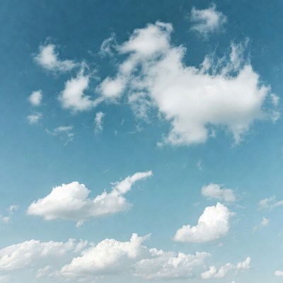 Fluffy white clouds in blue sky