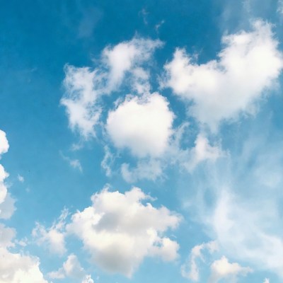 Fluffy white clouds in blue sky
