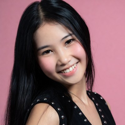 Asian woman smiling in black top