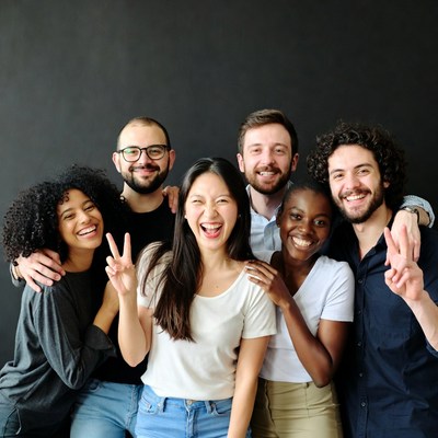 Diverse group smiling with peace signs