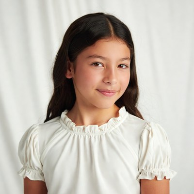 Young Asian girl smiling in white dress