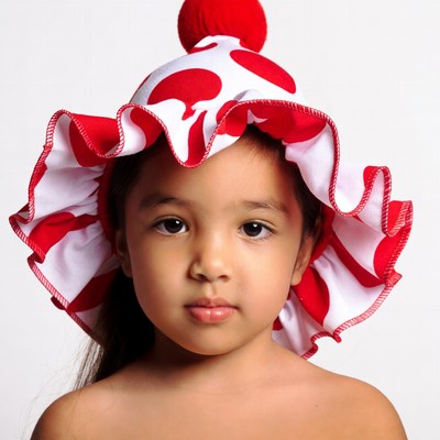Asian girl wearing red polka dot hat