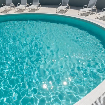 Round Swimming Pool with Lounge Chairs